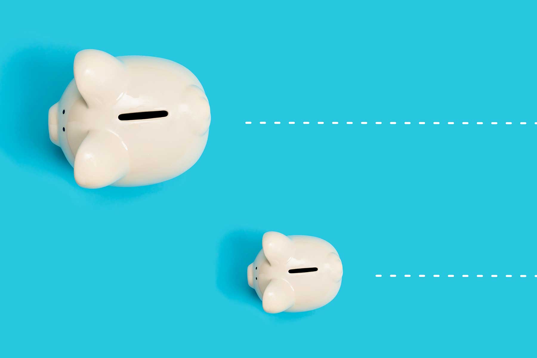 Editorial photograph: two piggy banks on separate dashed tracks, different tools moving at different speeds